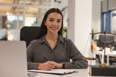 Photo of Portrait of smiling lawyer working at table in office