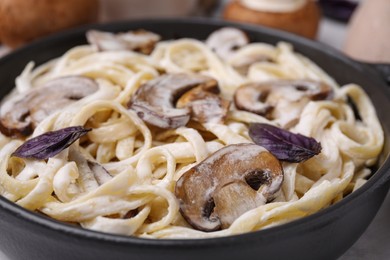 Photo of Delicious pasta with mushrooms in pan, closeup