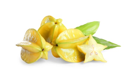 Photo of Cut and whole carambolas with green leaf on white background