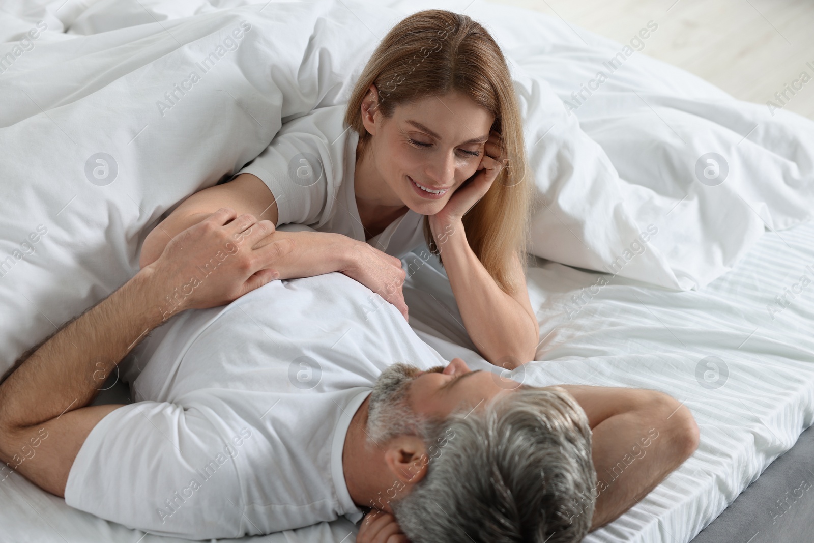 Photo of Lovely mature couple in bed at home