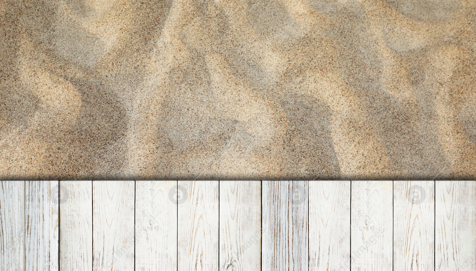 Image of Sand and white wooden planks outdoors, top view. Banner design