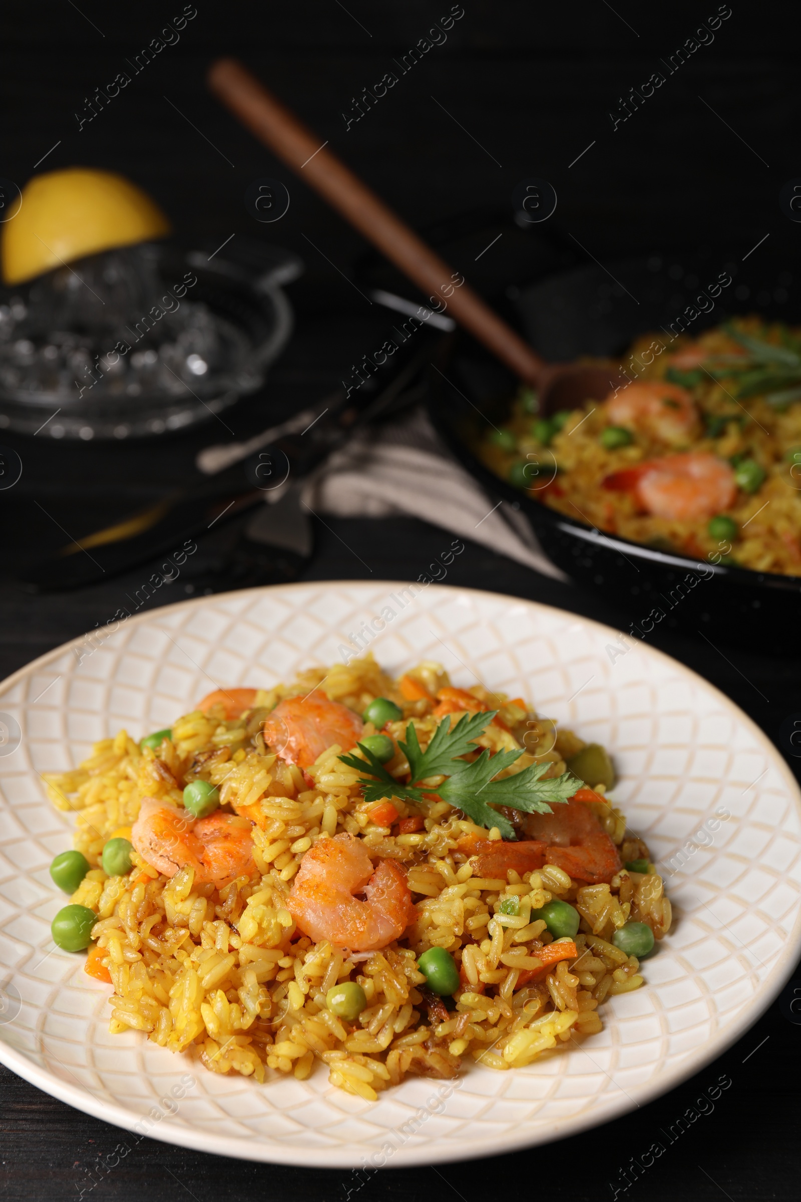 Photo of Tasty rice with shrimps and vegetables on table. Space for text