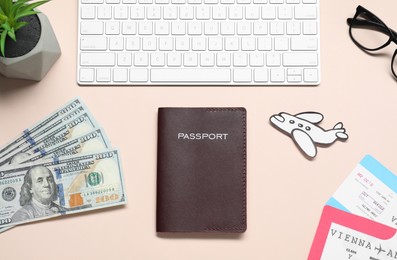 Photo of Flat lay composition with passport, keyboard and tickets on beige table. Business trip