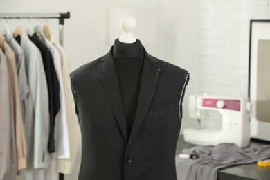 Photo of Mannequin with unfinished jacket in tailor shop