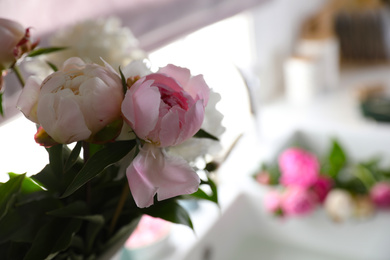 Photo of Closeup view of beautiful peonies against blurred background. Space for text