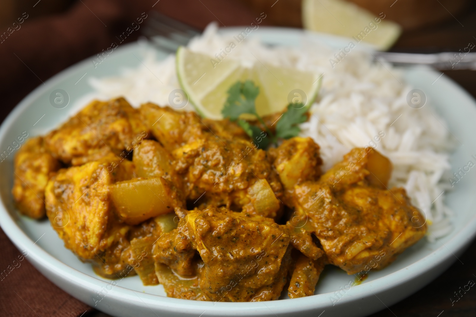 Photo of Delicious chicken curry with rice on table, closeup