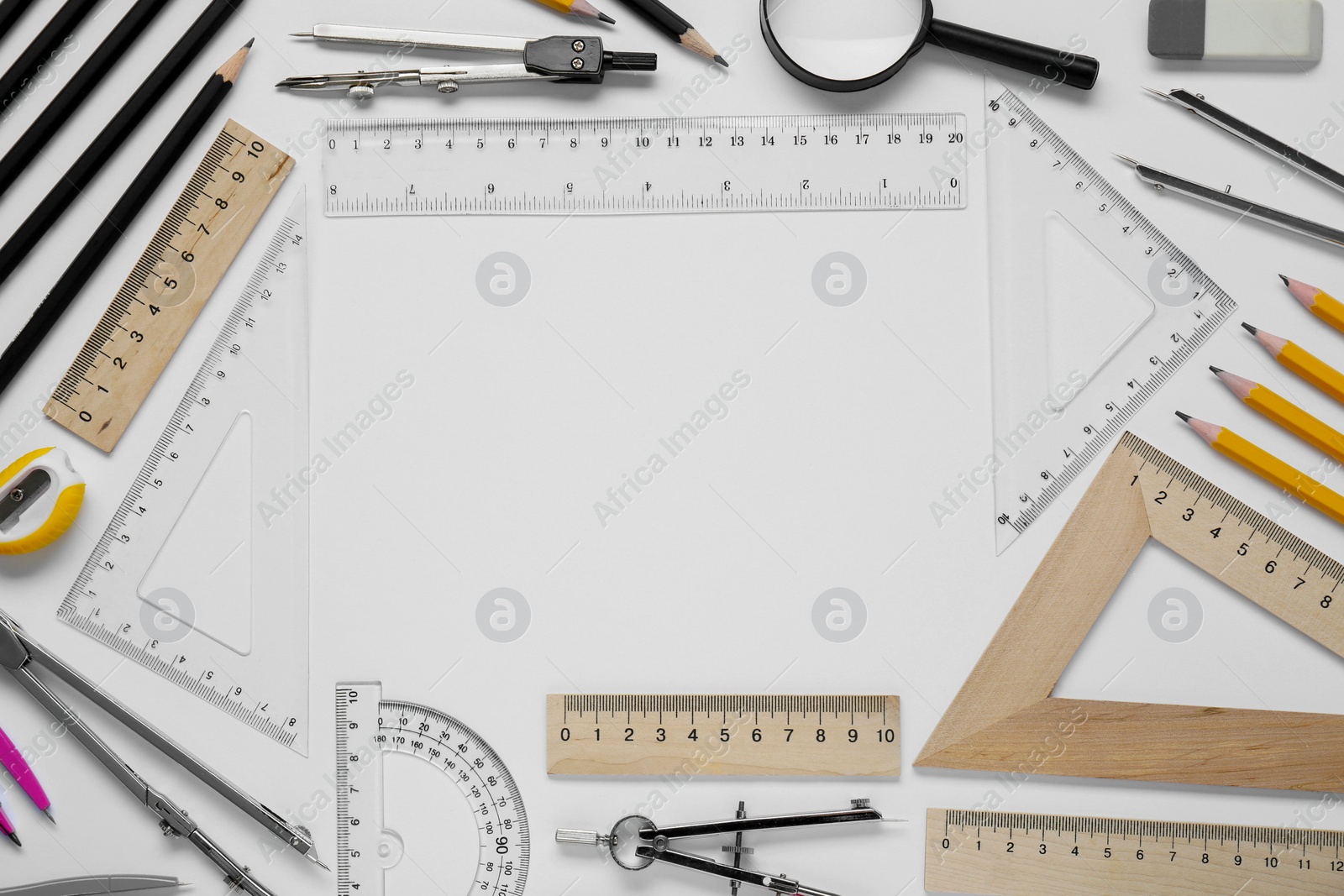 Photo of Flat lay composition with different rulers and compass on white background