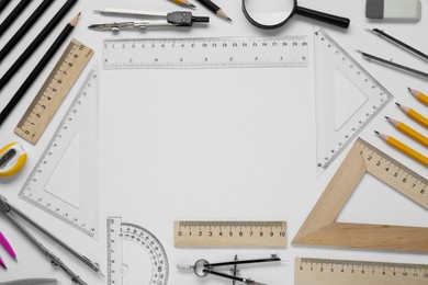 Photo of Flat lay composition with different rulers and compass on white background