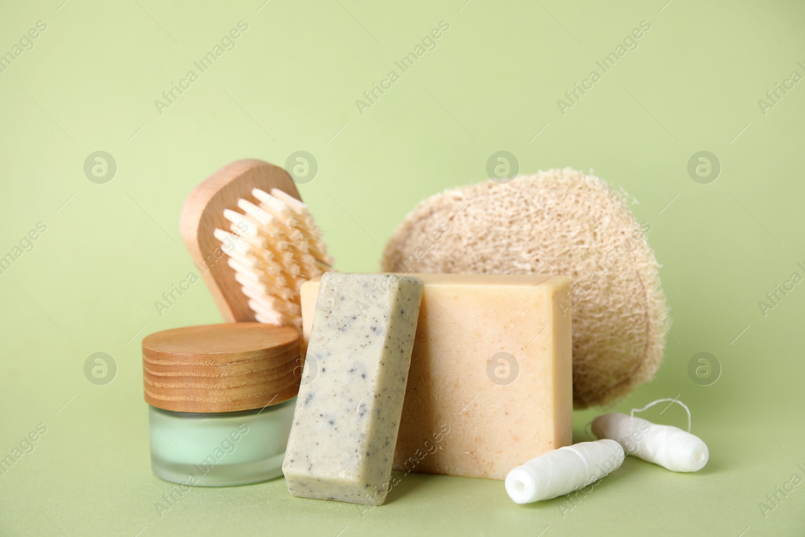 Photo of Eco friendly personal care products on light green background