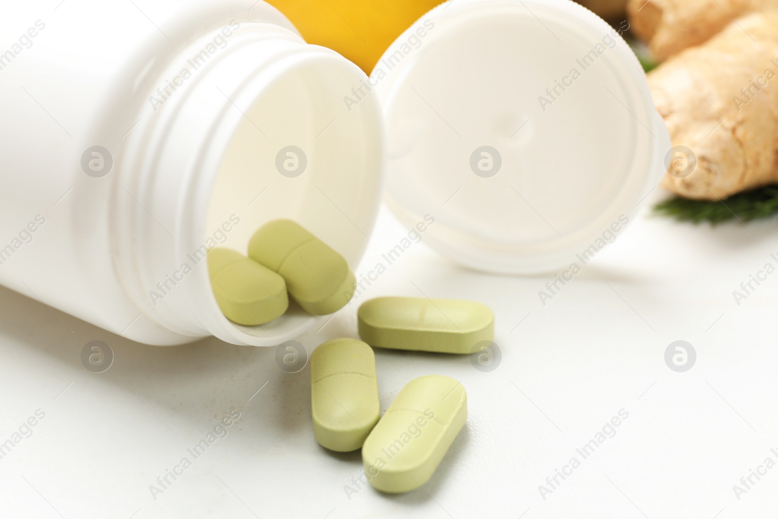 Photo of Dietary supplements in plastic bottle on white table, closeup