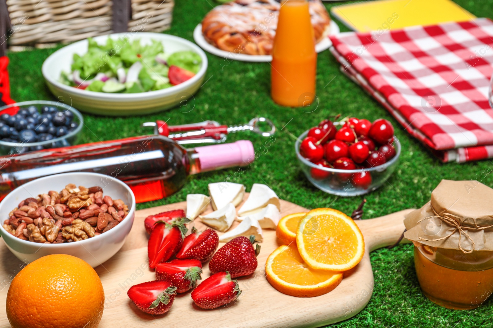 Photo of Many different products on green grass. Summer picnic