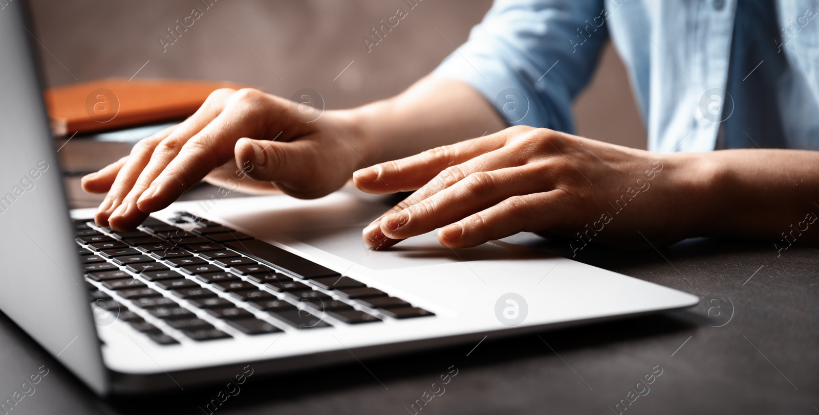 Image of Woman working on computer at table indoors, closeup. Banner design