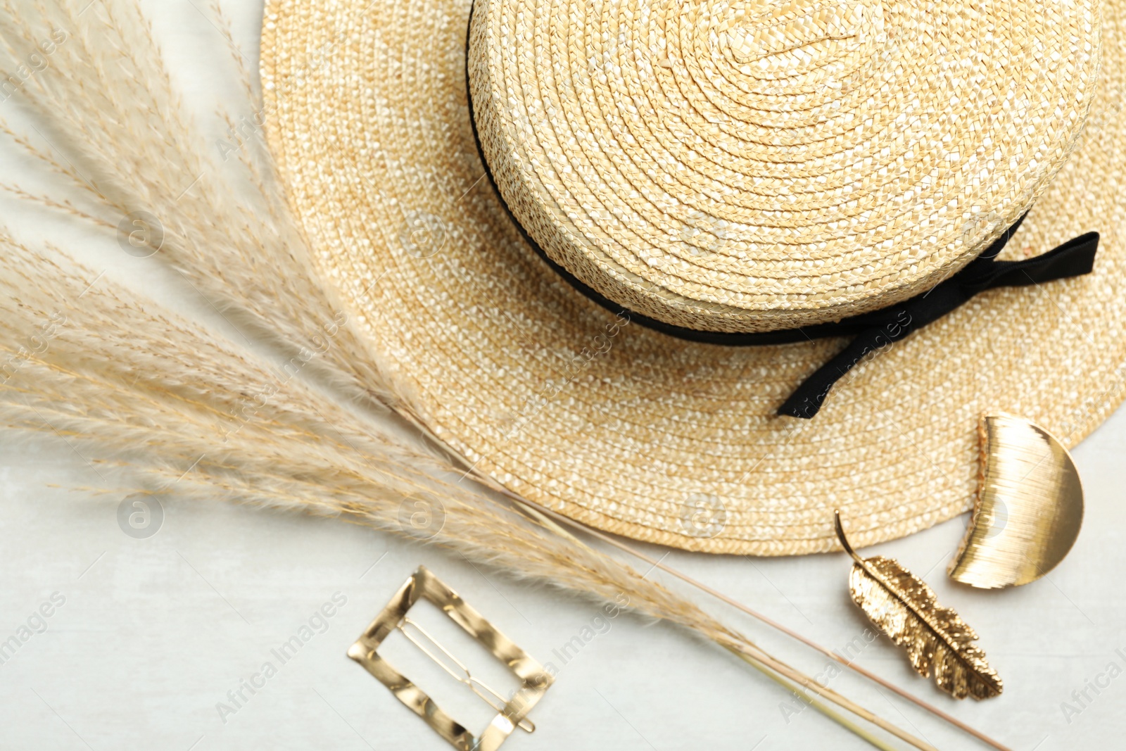 Photo of Beautiful different hair clips and hat on white table, flat lay