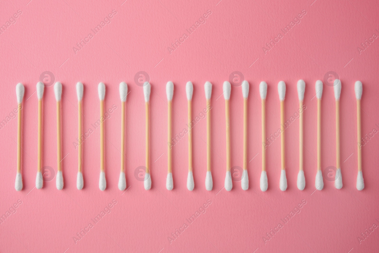 Photo of Many clean cotton buds on pink background, flat lay