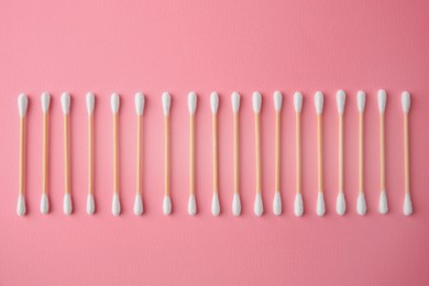 Photo of Many clean cotton buds on pink background, flat lay