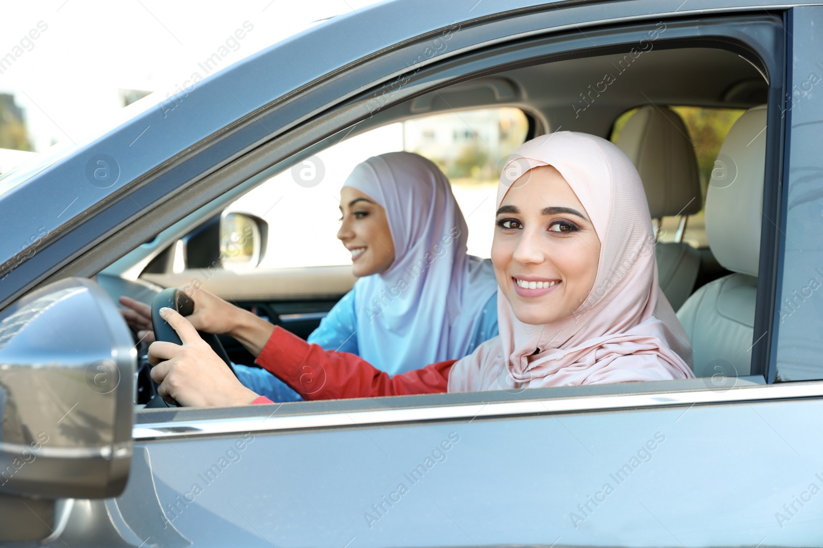 Photo of Female Muslim driver and her friend in car