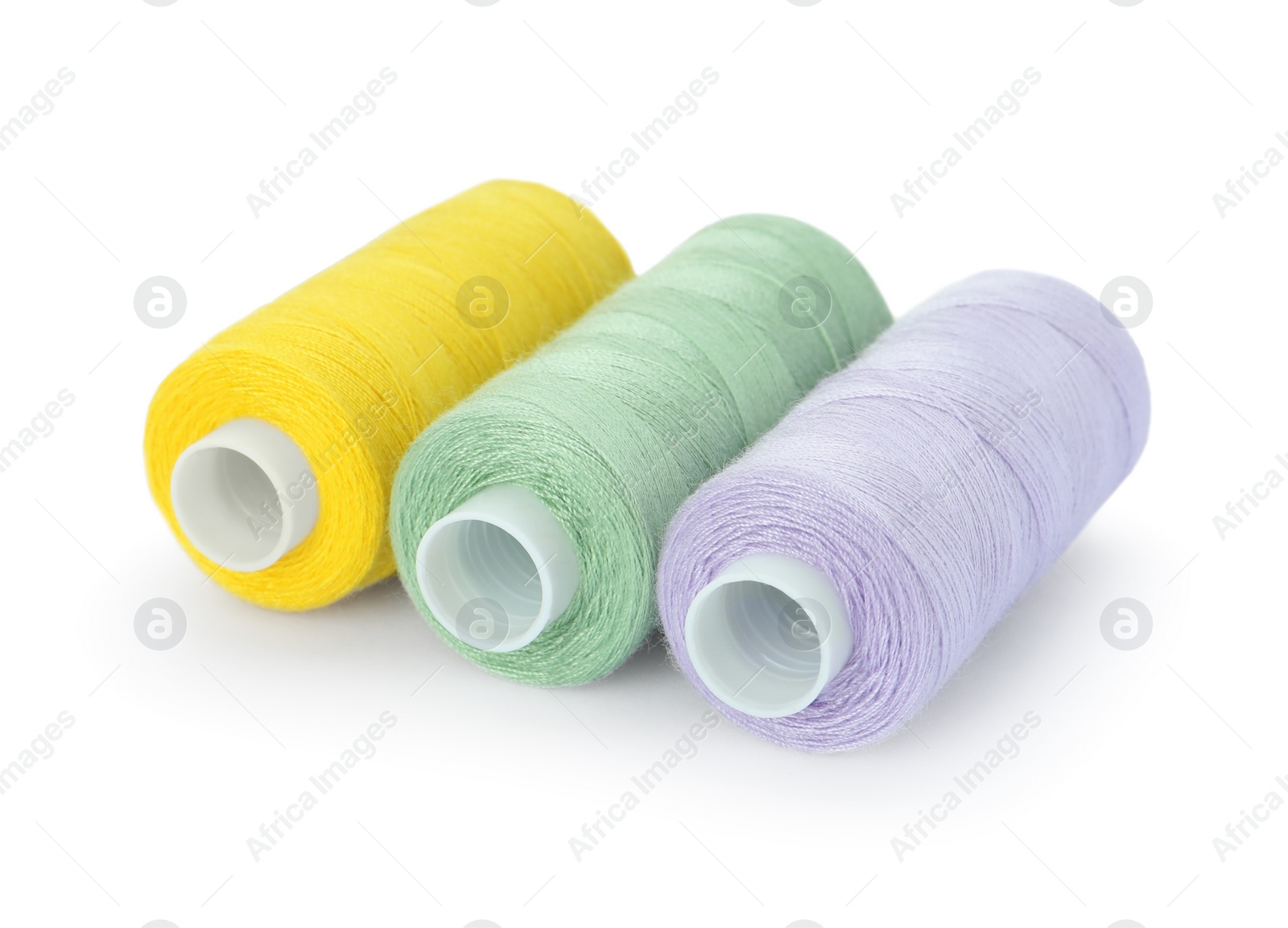 Photo of Different colorful sewing threads on white background