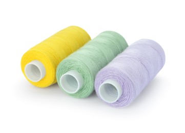 Photo of Different colorful sewing threads on white background