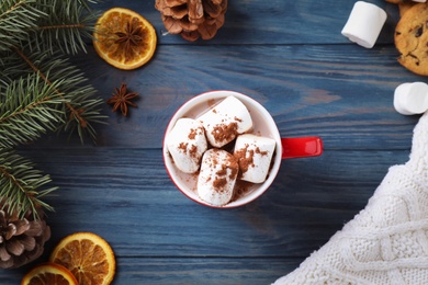 Photo of Flat lay composition of tasty cocoa with marshmallows on blue wooden table