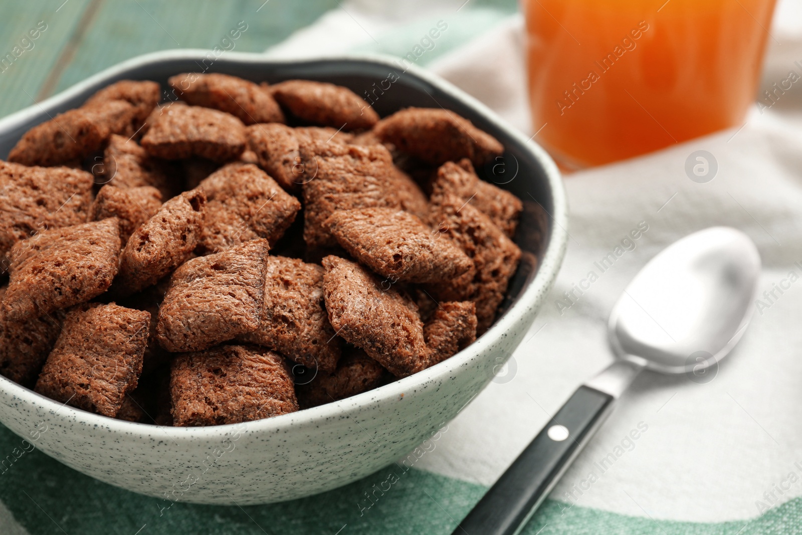 Photo of Bowl of sweet crispy corn pads on kitchen towel, closeup. Breakfast cereal