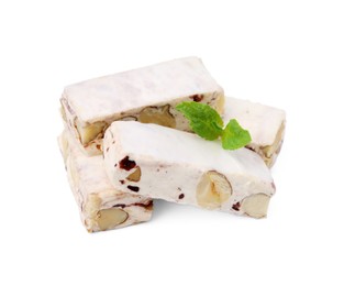 Photo of Pieces of delicious nougat and mint on white background