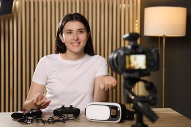 Photo of Smiling technology blogger recording gaming video review at home