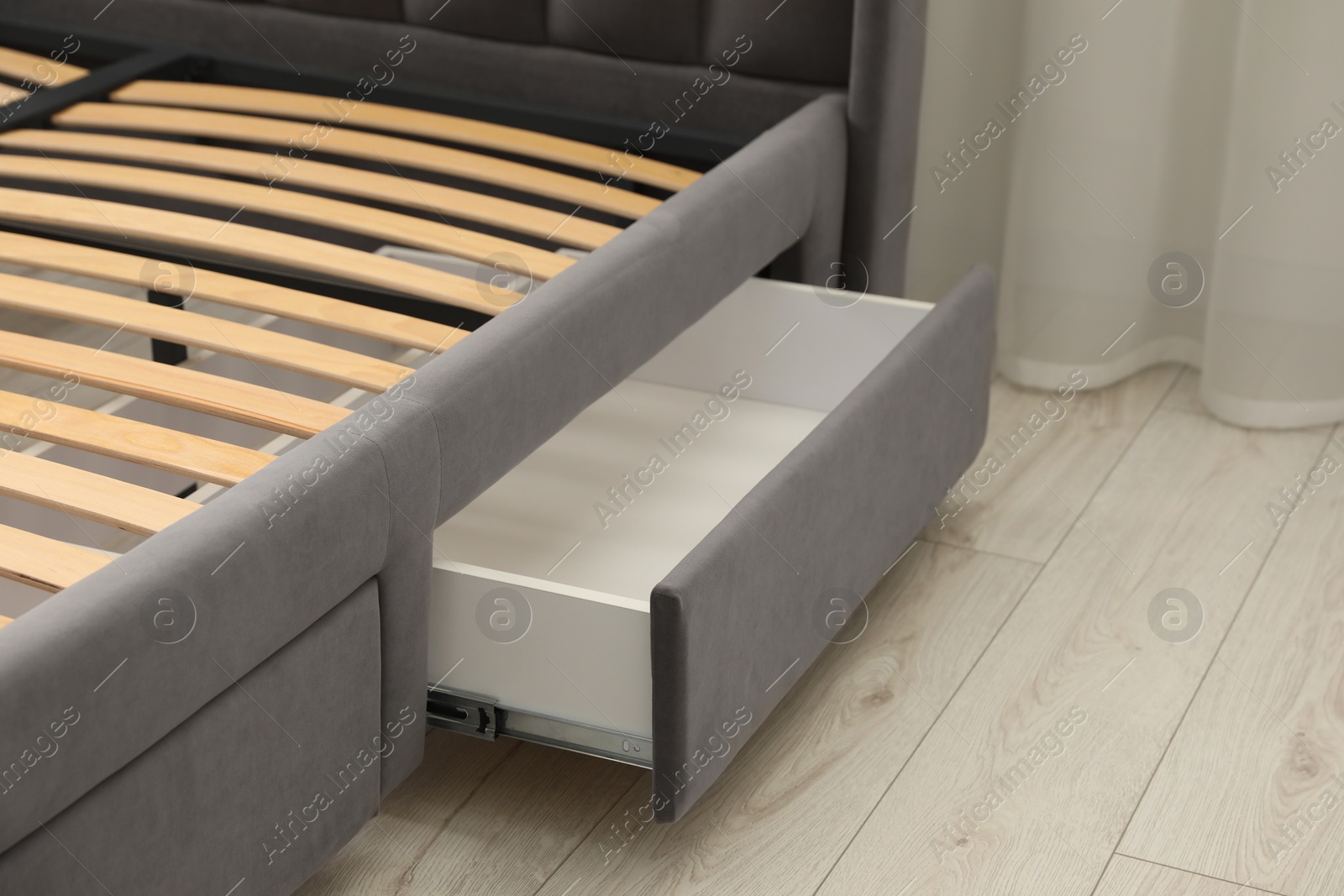 Photo of Storage drawer for bedding under modern bed in room