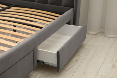 Storage drawer for bedding under modern bed in room