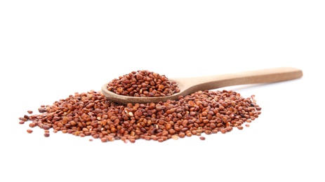 Pile of red quinoa and spoon on white background