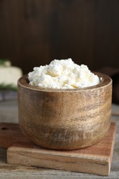 Photo of Delicious tofu cream cheese in bowl on wooden table