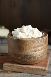 Delicious tofu cream cheese in bowl on wooden table