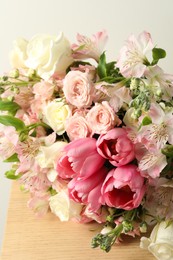 Photo of Beautiful bouquet of fresh flowers on wooden table, closeup