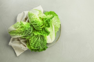 Fresh ripe Chinese cabbages on light grey table, top view. Space for text