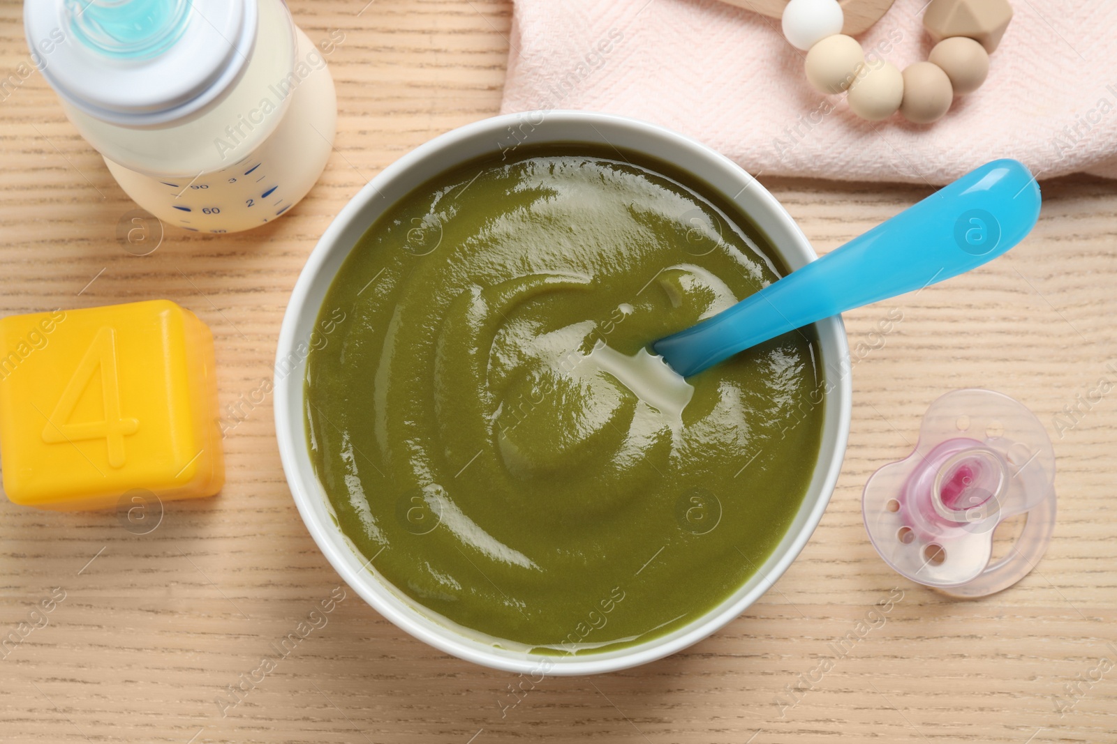 Photo of Flat lay composition with healthy baby food on wooden table