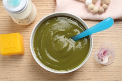 Flat lay composition with healthy baby food on wooden table