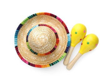 Photo of Mexican sombrero hat and maracas isolated on white, top view