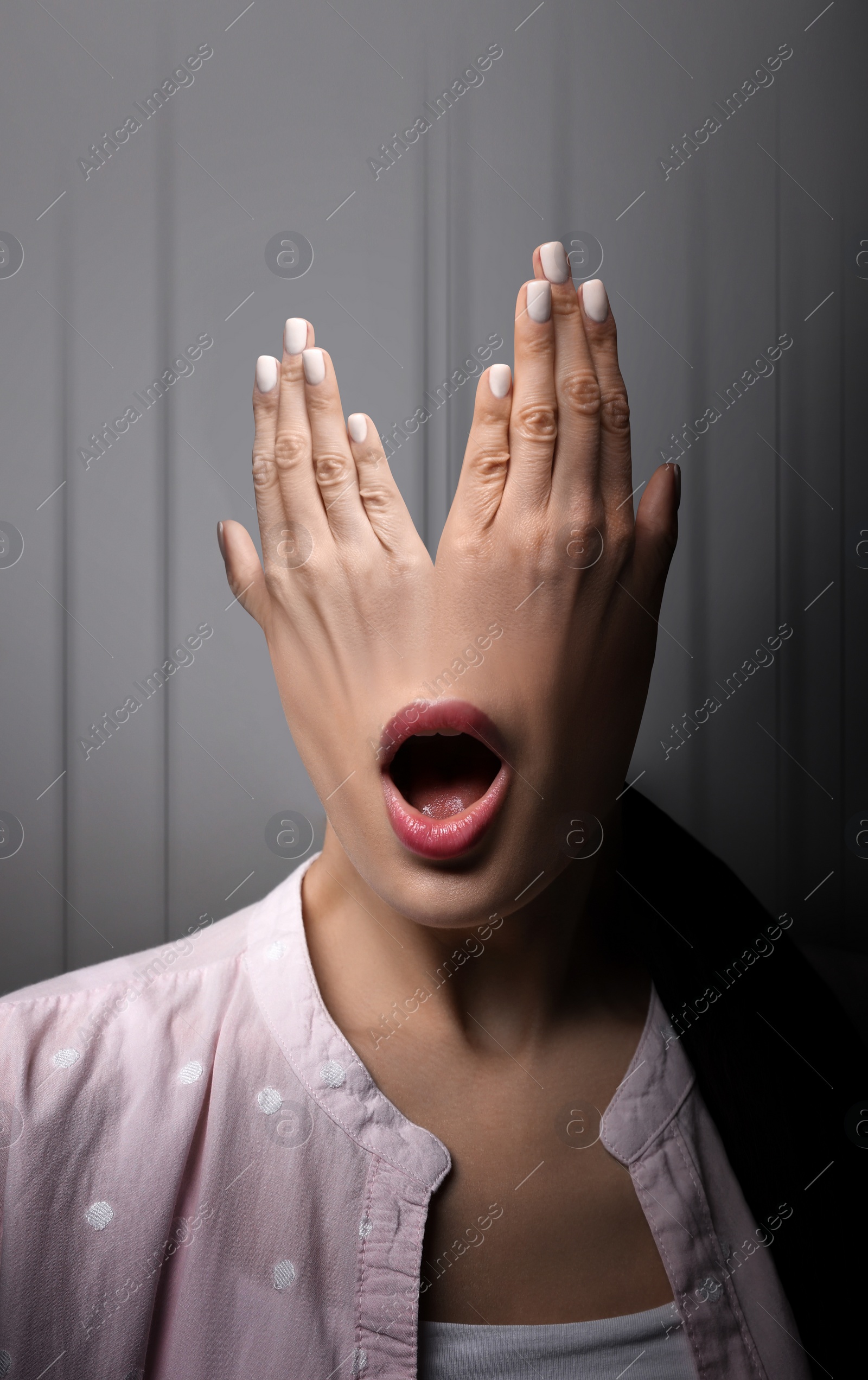 Image of Hallucinations. Shocked woman with mouth on hands instead of head on light grey background