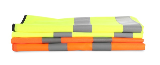 Photo of Reflective vests isolated on white. Safety equipment