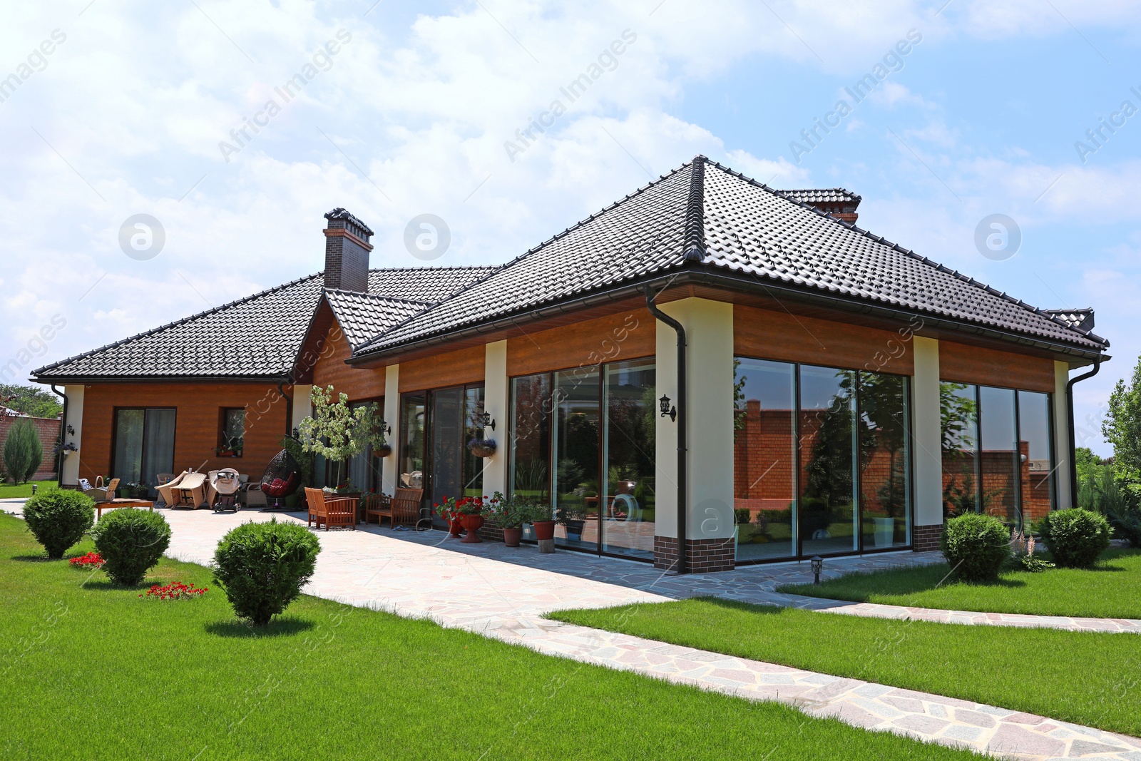 Photo of Modern house and beautiful garden on sunny day