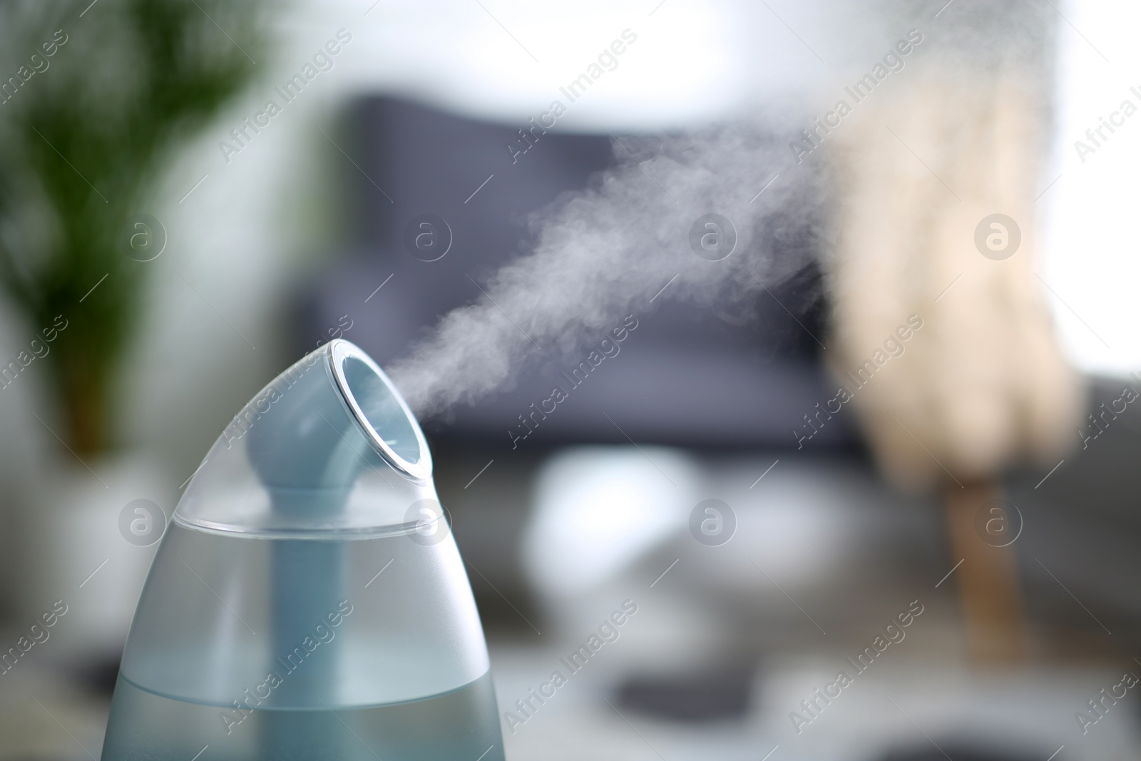 Photo of Modern air humidifier indoors, closeup. Space for text