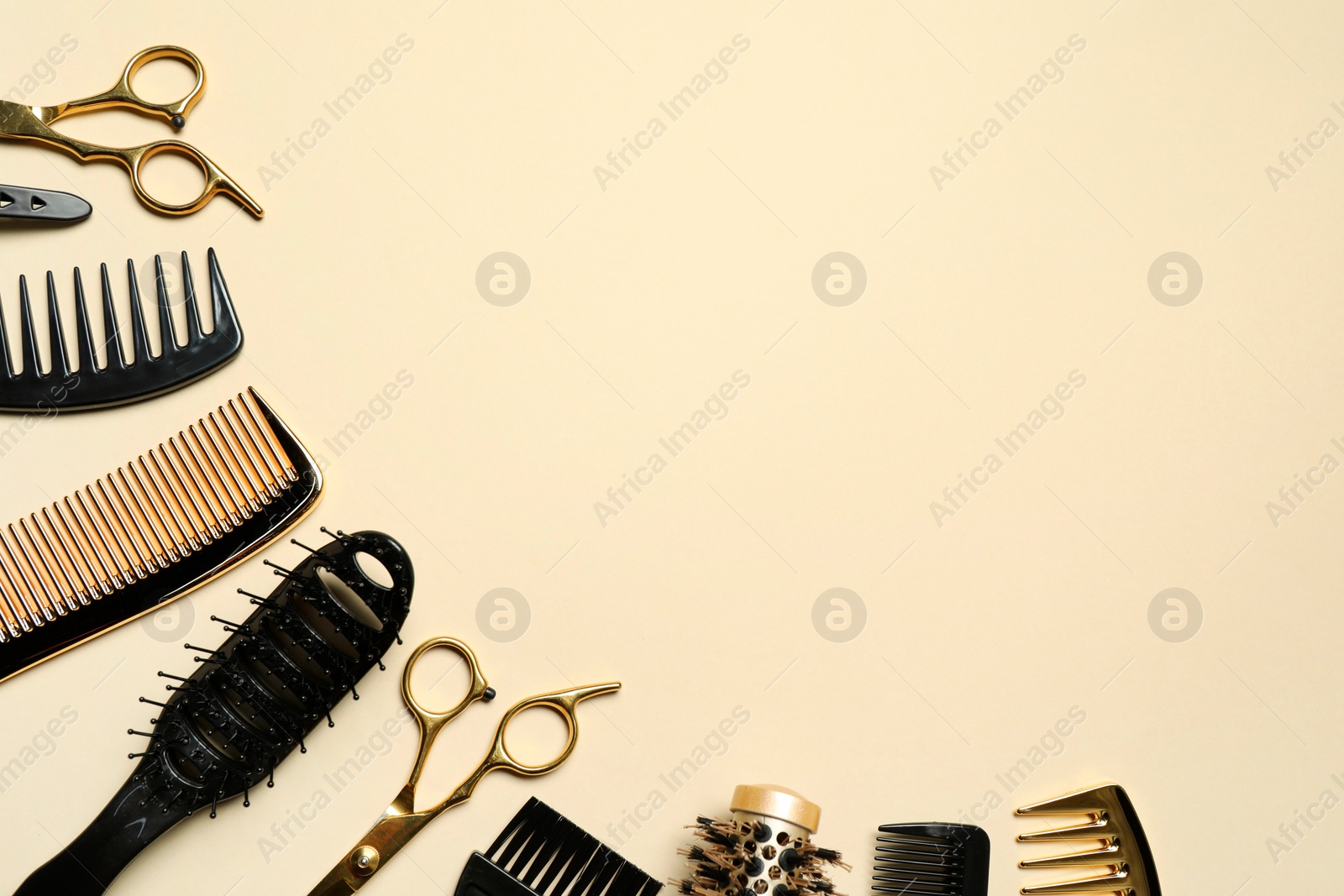 Photo of Hairdressing tools on beige background, flat lay. Space for text