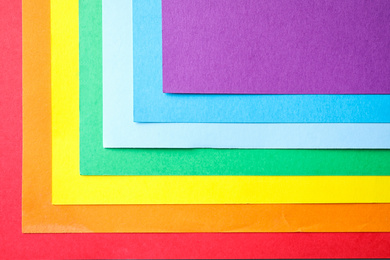 Photo of Sheets of multicolored paper, top view. Rainbow palette