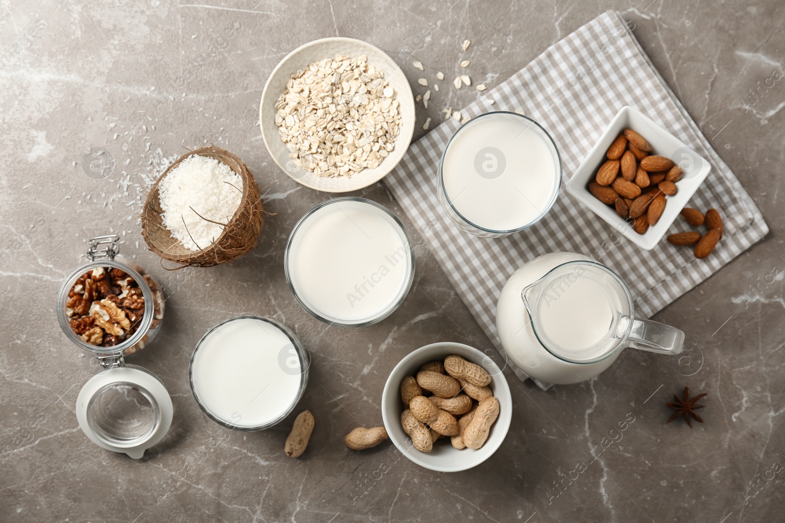 Photo of Composition with different types of milk and ingredients on light background