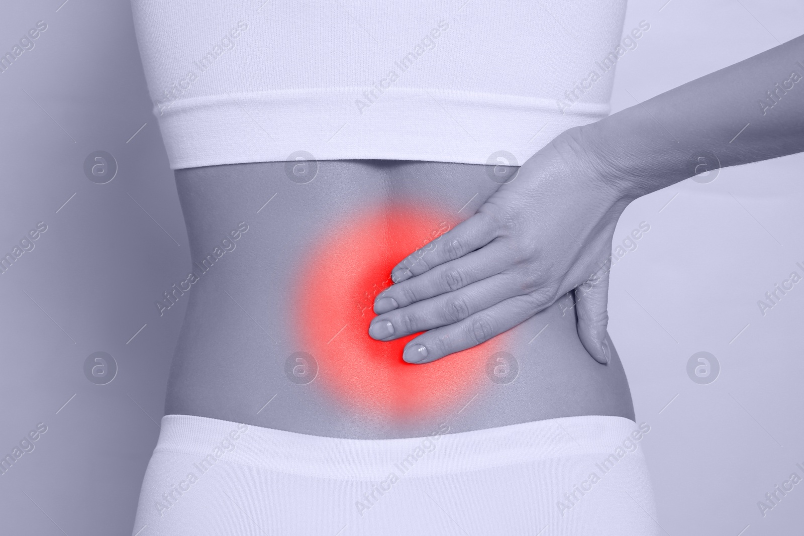 Image of Woman suffering from back pain on light background, closeup