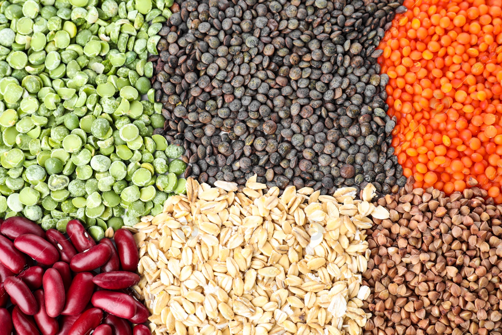 Photo of Different grains and cereals as background, top view