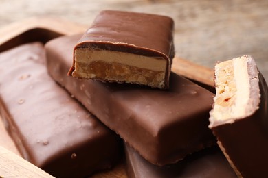 Tasty chocolate bars with nougat on table, closeup