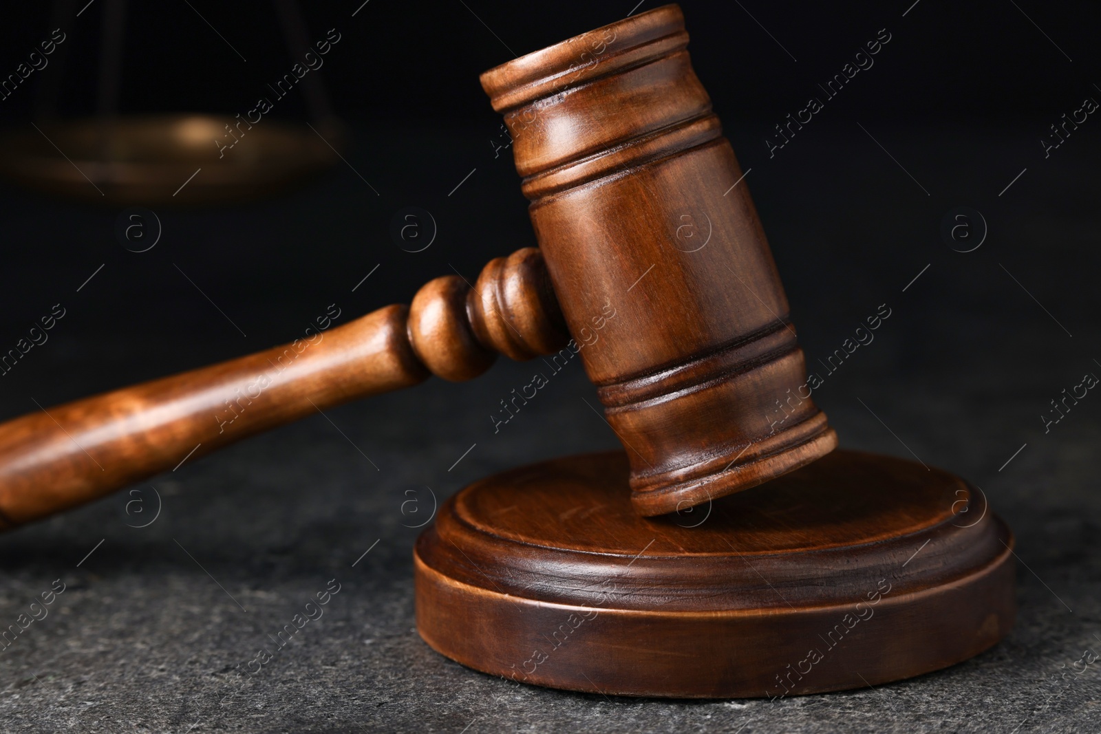 Photo of Law concept. Judge's gavel on grey textured table, closeup