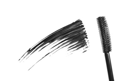 Photo of Smear of mascara and applicator isolated on white, top view