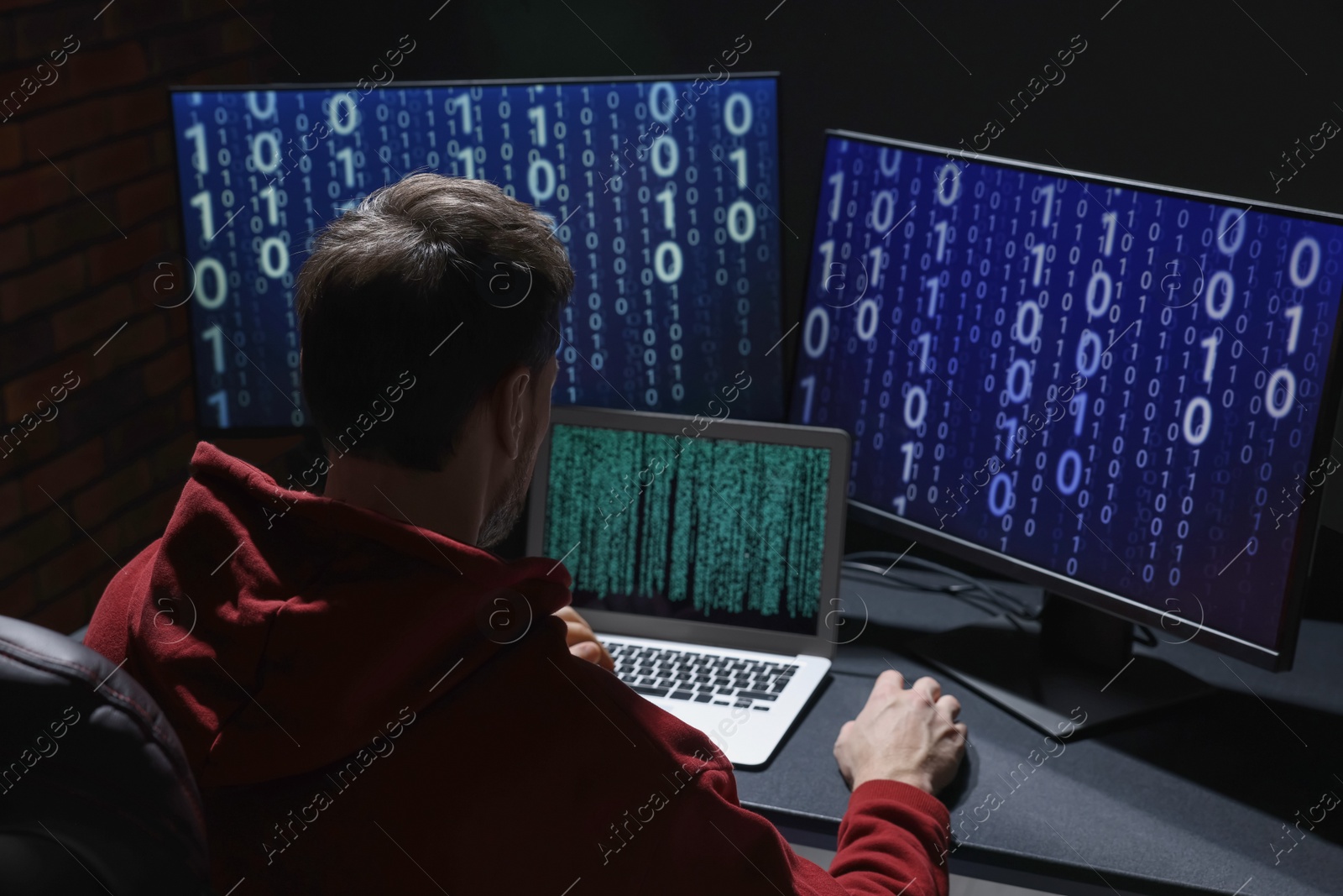 Photo of Hacker working with computers in dark room. Cyber attack