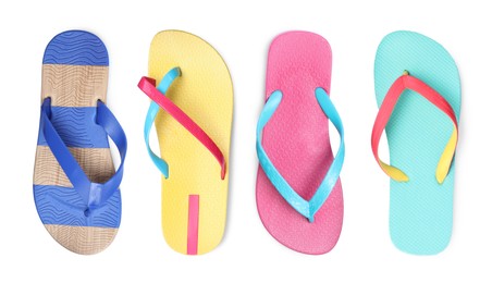 Set with different flip flops on white background, top view 